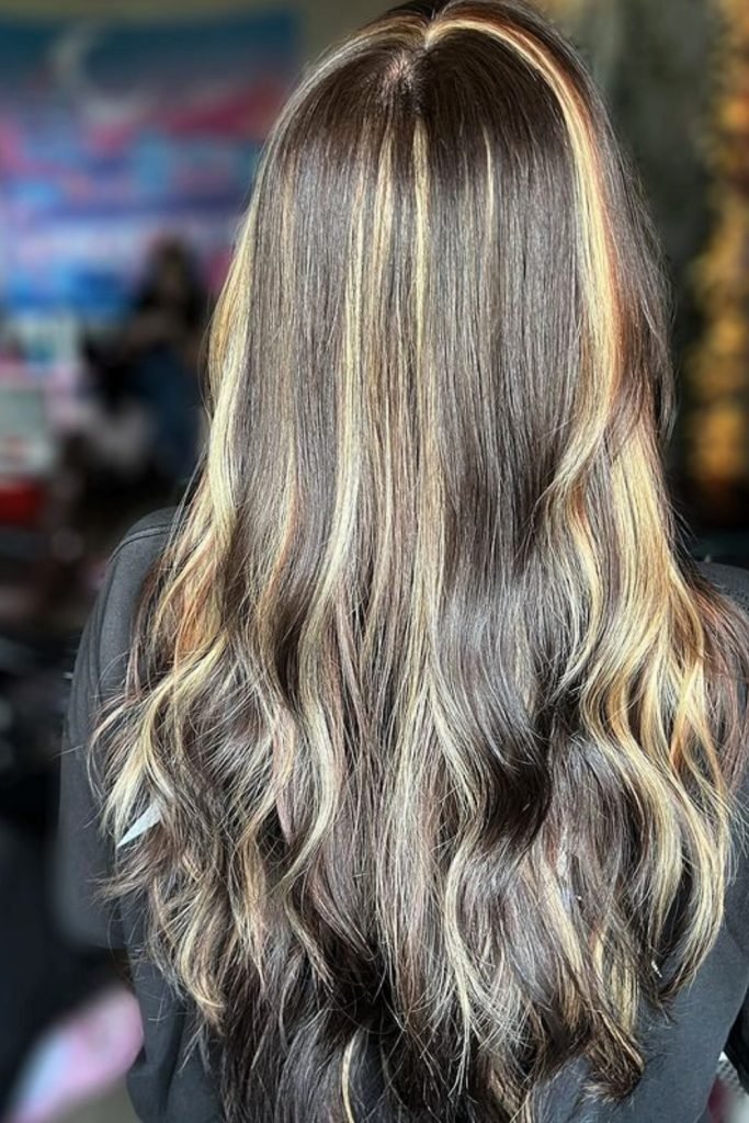 1. Sunlit Dark Brown Hairstyle with Blonde Highlights