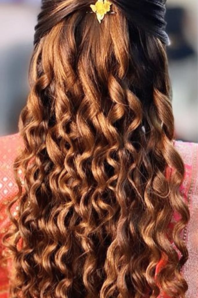 Loose Cascading Curls with a Floral Accent
