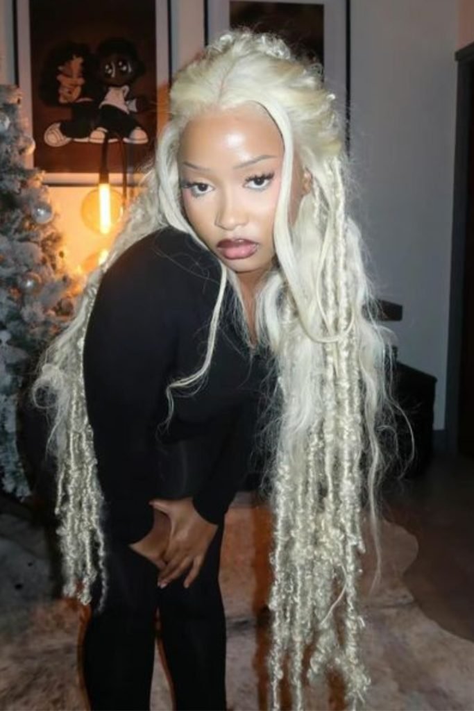 14. Platinum Blonde Goddess Braids with Loose Waves