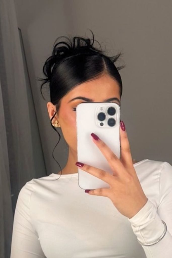 17. Messy Top Knot with Strands