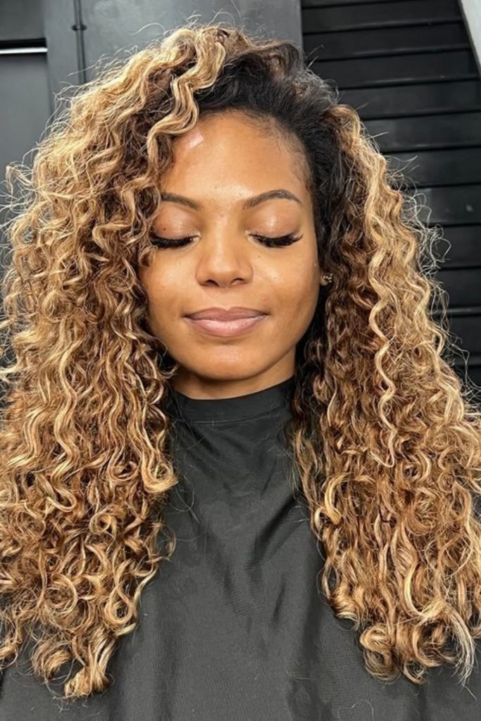 Side-Parted Blonde Highlights with Voluminous Curls