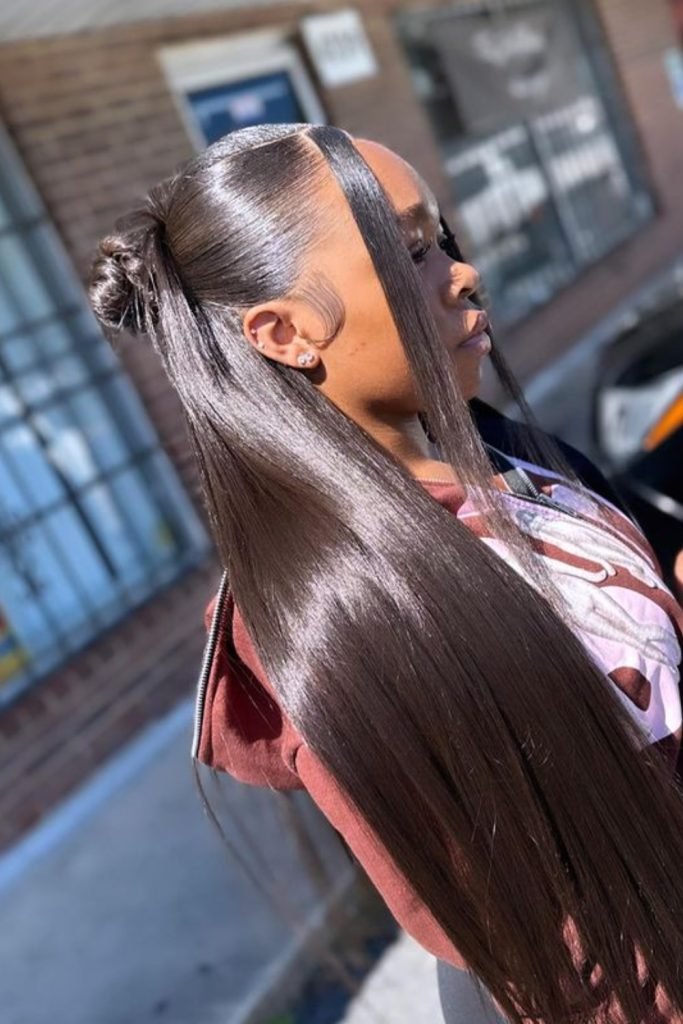 26. Sleek Top Knot with Flowing Length