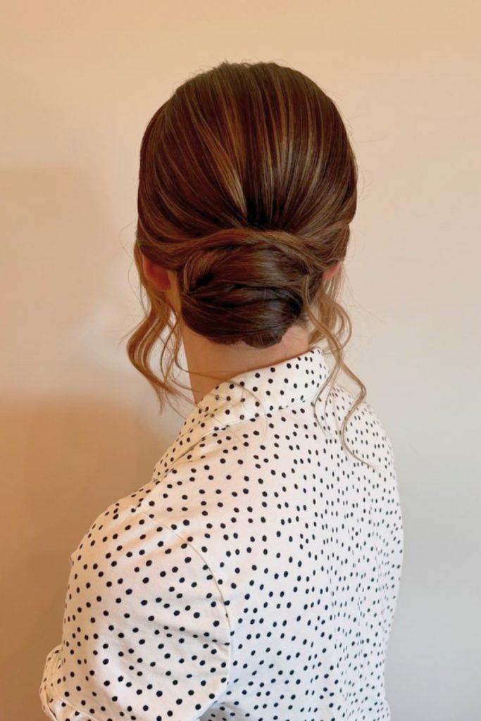 Polished Low Bun with Soft Tendrils