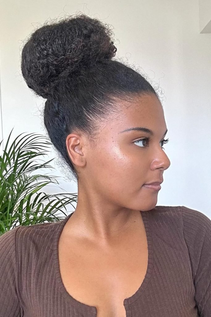 29. Voluminous High Bun Hairstyle for 4C Hair