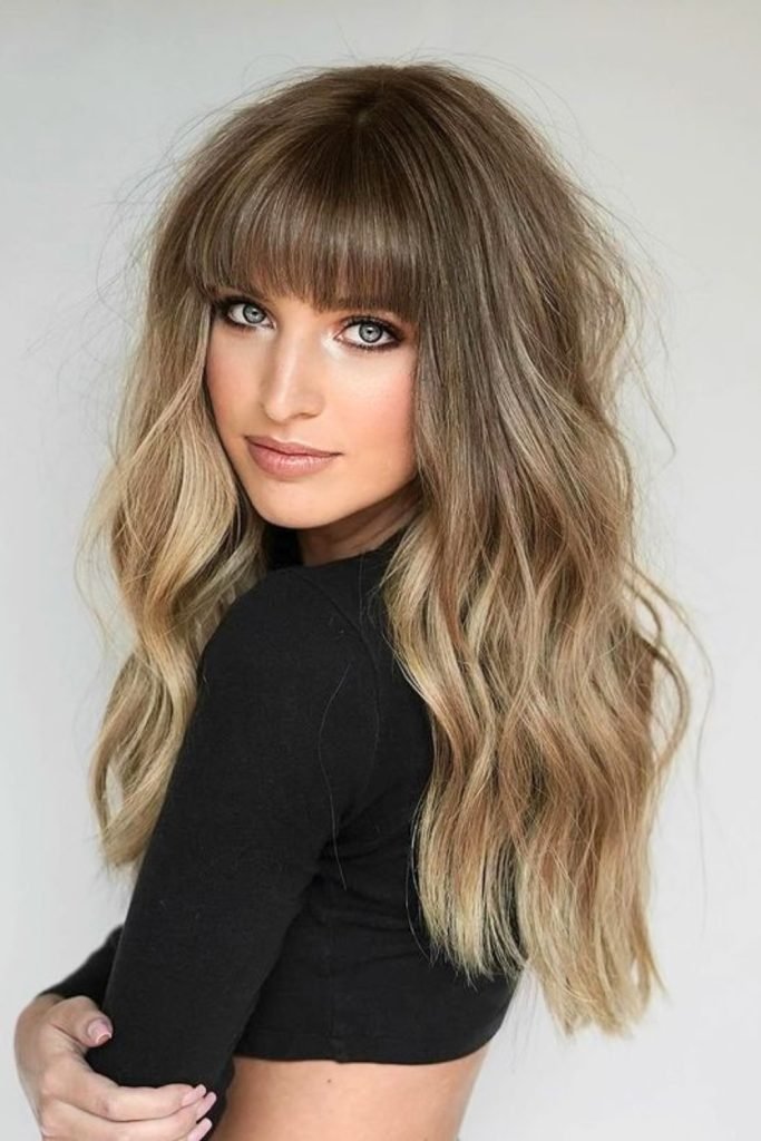 Soft Blonde Waves with Full Fringe Style