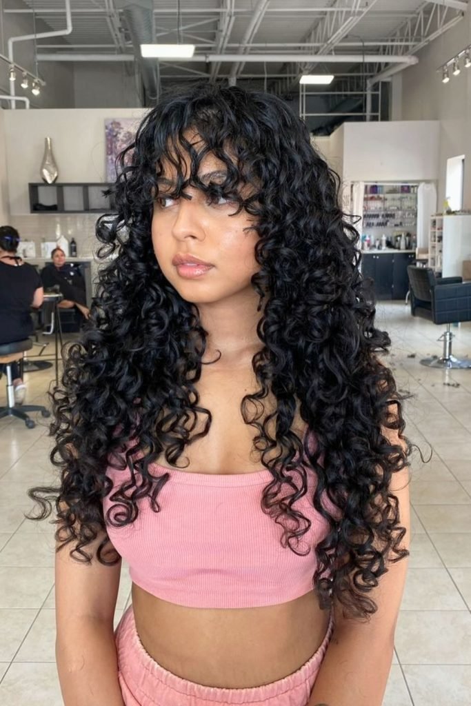 Cascading Curls with Wispy Bangs