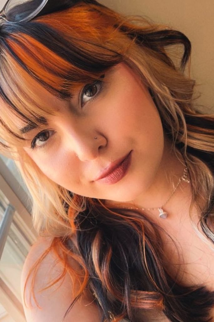 4. Fiery Bangs with Dark Streaks