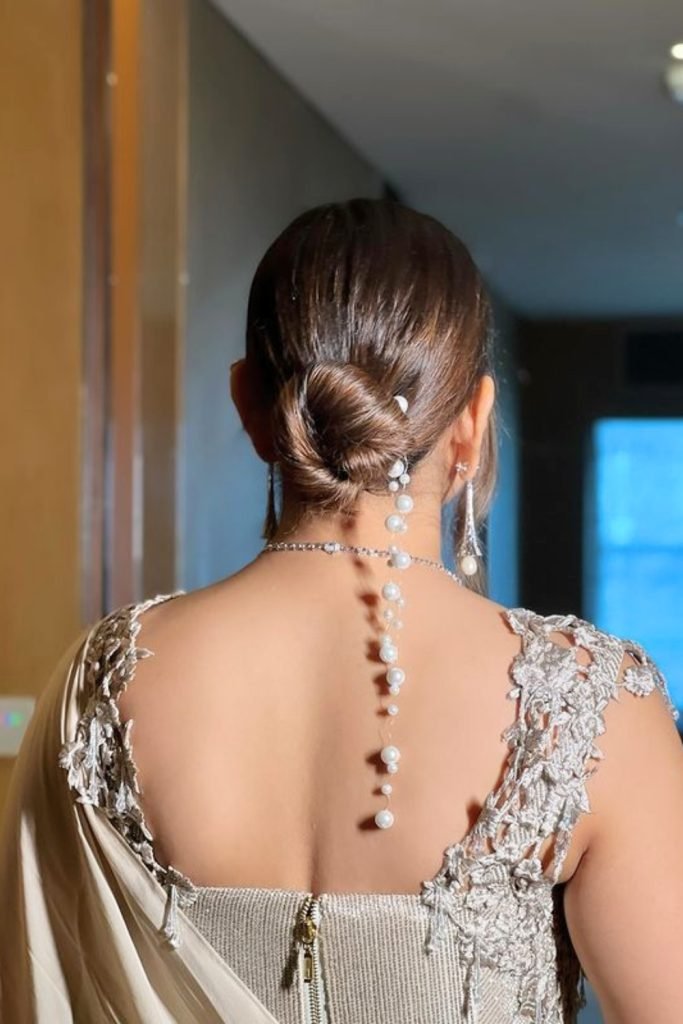 Sleek Pearl-Embellished Low Bun Hairstyle