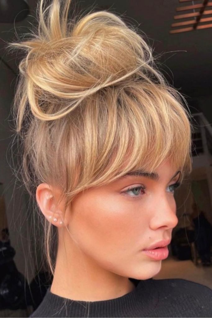 7. Top Knot with Fringe – Chic and Timeless Hairstyle
